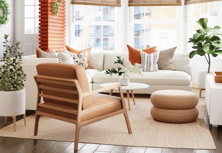 A photo of a livingroom setting with a couch, footstool, white and brown fabric for upholstery